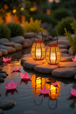 AI Studio Photo - Front face view wearing hat, looking at camera, hat brim visible. CAMERA SHOT: A medium shot focusing on the two lanterns placed on smooth, grey river stones, with a shallow depth of field blurring the background. [Half body styled]