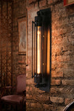 AI Studio Photo - Standing facing the camera, natural confident posture, arms relaxed at sides, front view, full body visible. CAMERA SHOT: Medium shot focusing on the wall sconce and its immediate surroundings, showcasing the texture of the brick wall and the warm light it emits. [Half body styled]