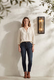 AI Studio Photo - Standing facing the camera, natural confident posture, arms relaxed at sides, front view, full body visible. CAMERA SHOT: Medium shot showcasing one lamp mounted on a wall, with a hint of the surrounding environment. [Full body]