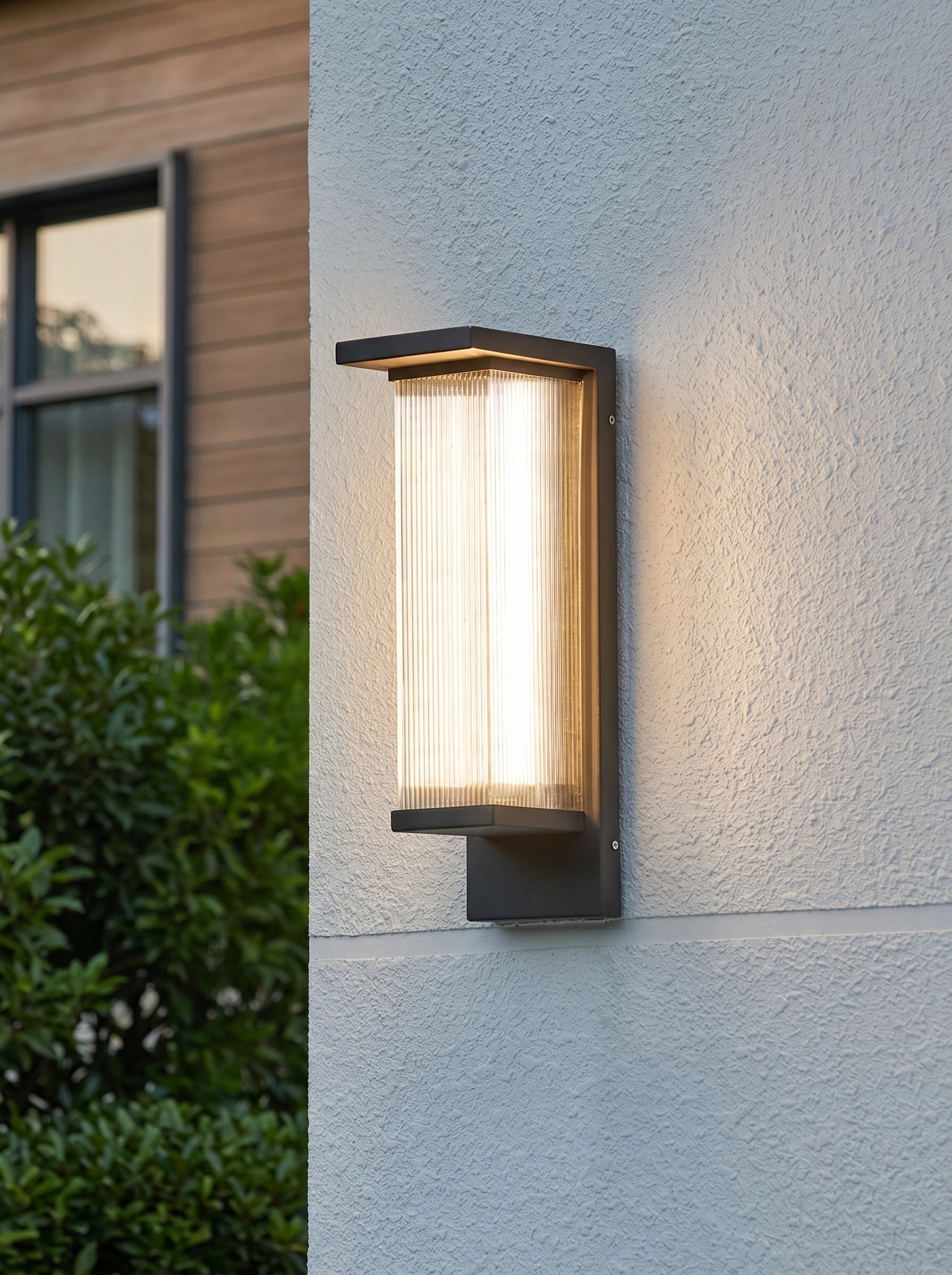 AI Studio Photo - Standing facing the camera, natural confident posture, arms relaxed at sides, front view, full body visible. CAMERA SHOT: A medium shot focusing on the wall lamp mounted on a textured exterior wall, showcasing its design and the light it emits. [Full body]