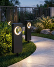 AI Studio Photo - Standing facing the camera, natural confident posture, arms relaxed at sides, front view, full body visible. CAMERA SHOT: A medium shot focusing on one or two of the pathway lights, with a slightly blurred background to emphasize the product. [Full body]