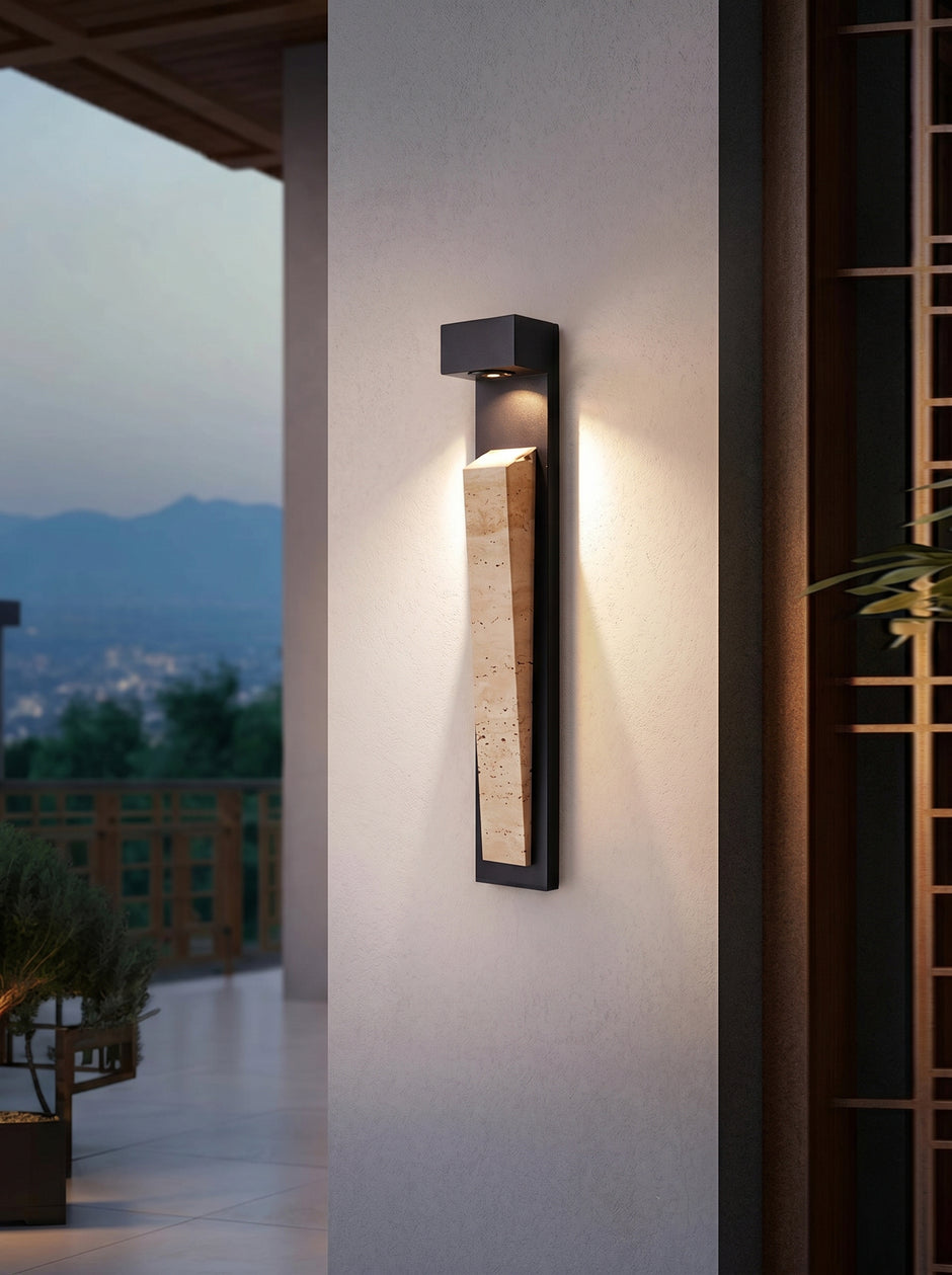 AI Studio Photo - Standing facing the camera, natural confident posture, arms relaxed at sides, front view, full body visible. CAMERA SHOT: Medium shot focusing on the wall light, with a hint of the surrounding architectural elements and the distant landscape. [Half body styled]